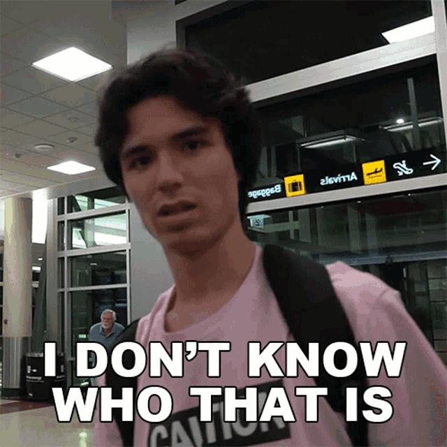 a man wearing a pink shirt that says i don t know who that is