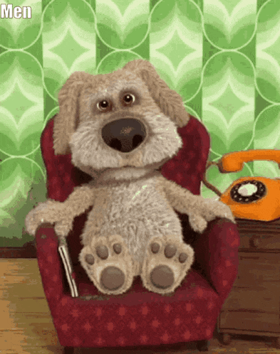 a stuffed dog is sitting in a red chair next to an orange telephone and the word men