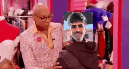 a man in a suit is holding a picture of a man in a hoodie .