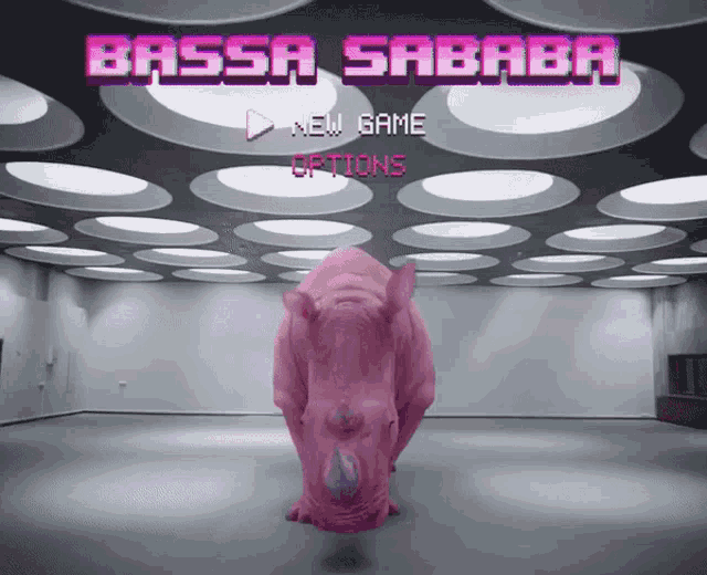 a pink rhino stands in front of a bassa sababa game