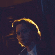 a close up of a man 's face in a dark room
