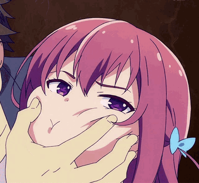 a girl with pink hair and purple eyes is being held by a man 's hands