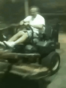 a man is sitting in a go kart .