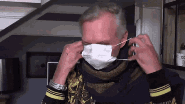 a man wearing a purple scarf and a face mask