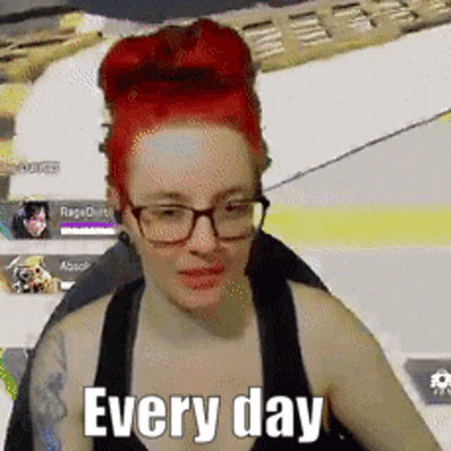 a woman with red hair wearing glasses and a black tank top says every day