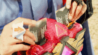 a person is playing with a toy that looks like a dragon .