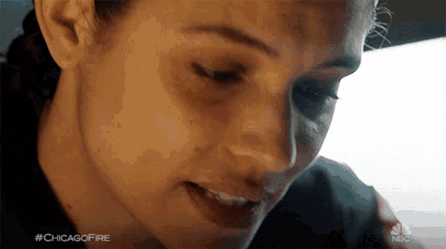 a close up of a woman 's face with the hashtag #chicagofire in the corner