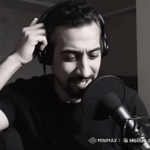 a man wearing headphones stands in front of a microphone that says hailuo a