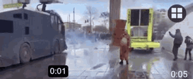 a man in a spongebob costume is standing in front of a riot vehicle .