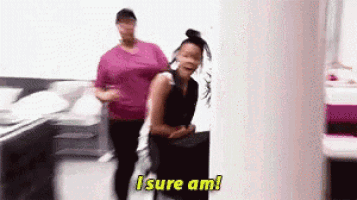 two women are standing next to each other in a room and one of them is saying i sure am .