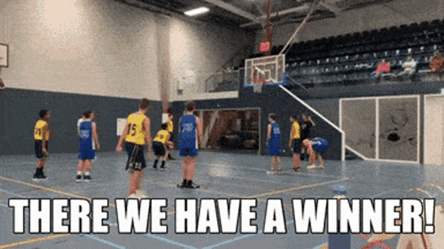a basketball game is being played in a gym with the words there we have a winner