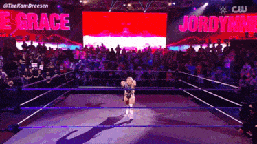 a woman in a wrestling ring with the words jordynne grace on the screen behind her