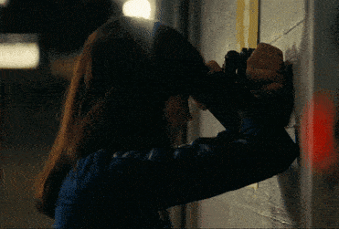 a woman looking through binoculars on a wall