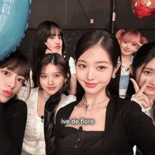 a group of girls posing for a picture with ive de fiore written on the bottom right