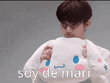 a man holding a stuffed animal that says soy de mari on it