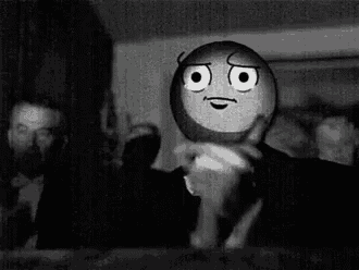 a black and white photo of a cartoon character with a smiley face on his head .