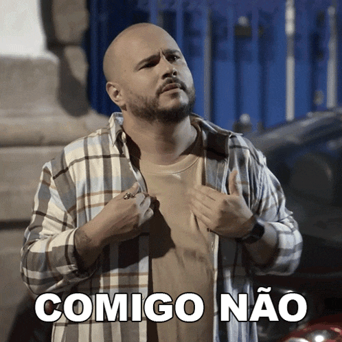 a man in a plaid shirt is standing in front of a sign that says comigo não