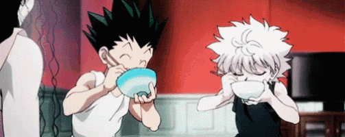 two anime characters are eating from bowls with chopsticks in a room .