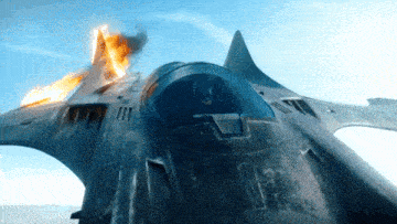 a fighter jet is flying in the sky with flames coming out of the cockpit