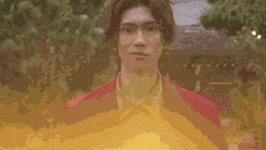 a blurred image of a man 's face with a yellow background