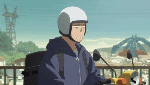 a man wearing a white helmet and a blue hoodie is riding a motorcycle