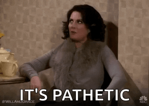 a woman is sitting at a table and says it 's pathetic