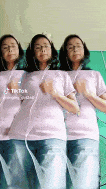 three women wearing headphones and a pink shirt with tiktok written on it