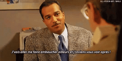 a man in a suit and tie is talking to another man in a foreign language .