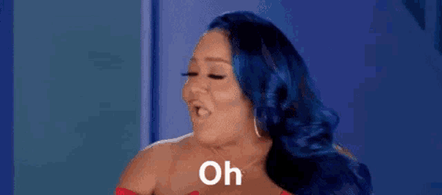 a woman with blue hair is making a funny face and saying `` oh '' .