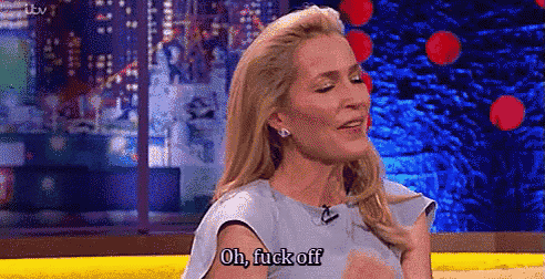 a woman is sitting on a stage with her eyes closed and saying `` oh , fuck off `` .