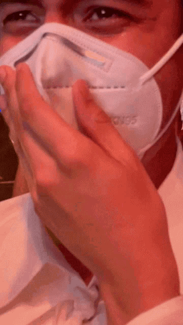 a man wearing a mask with the word sonos on it covering his mouth