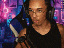 a man wearing headphones and glasses holds a microphone