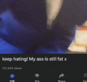 a man in a blue suit is dancing with the caption keep hating my ass is still fat