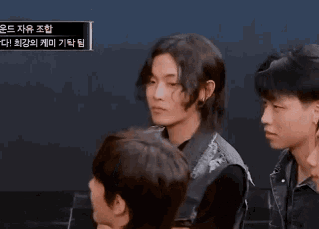 a group of young men are standing next to each other with a sign that says ' korean ' on it