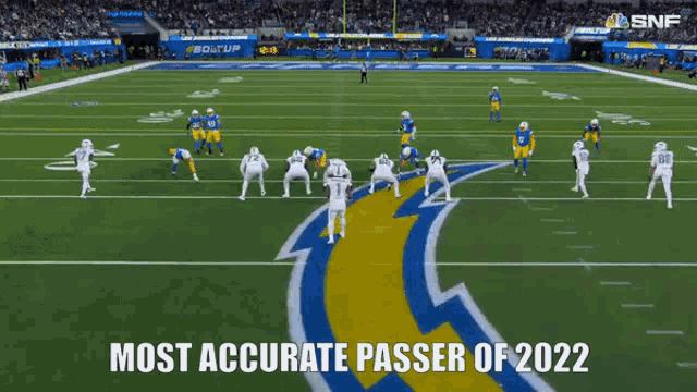a football game is being played on a field with the words `` most accurate passer of 2022 '' written on the screen .