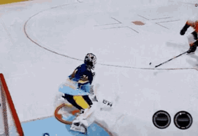 a hockey player with the number 74 on his jersey is laying on the ice
