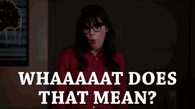 a woman wearing glasses stands in front of a sign that says whaaaaat does that mean