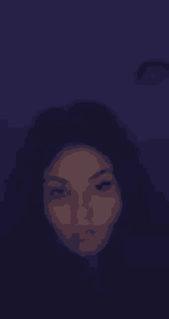 a blurry picture of a woman with her eyes closed .