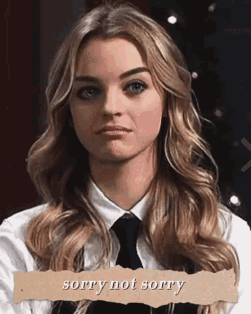 a woman in a white shirt and black tie says sorry not sorry on a piece of paper