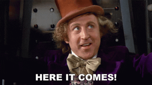 a man wearing a top hat and a bow tie says here it comes