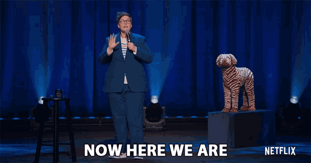 a netflix ad shows a woman standing next to a stuffed animal