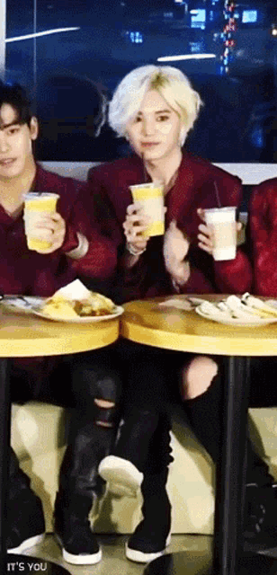 a group of people are sitting at a table with plates of food and drinks and the words " it 's you " on the bottom