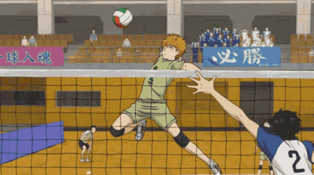 a volleyball player with the number 2 on his jersey jumps over the net