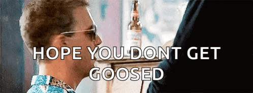 a man wearing sunglasses is talking to another man with the words hope you dont get goosed below him