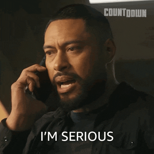 a man talking on a cell phone with the words i 'm serious written below him