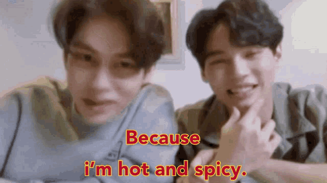 two men are sitting next to each other and one of them is saying because i 'm hot and spicy