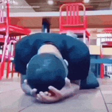 a person laying on the floor with their head on their hands