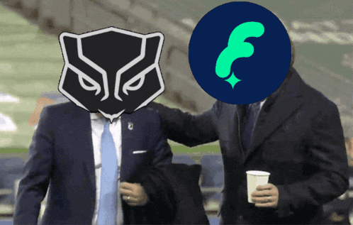 a man in a suit holds a cup next to another man with a shield on his head