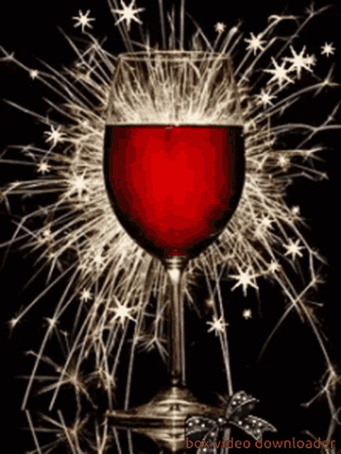 a glass of red wine is surrounded by sparklers and says box video downloader