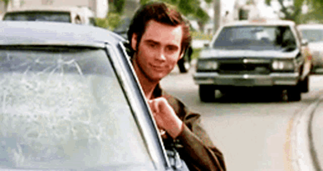 a man in a car with a broken windshield